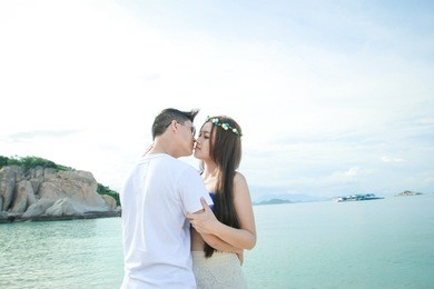 couple sit on rock on beach, couple have fun and enjoy the happiness together