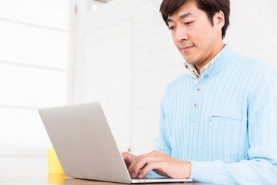 asian middle age man who uses laptop