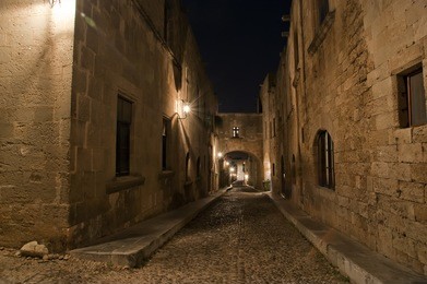 medieval avenue of the knights at night, a cobblestone street in rhodes citadel , greece
