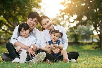 asian family portrait with happy people smiling at the park ,lifestyle and holiday concept.