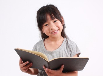 portrait of young happy girl with book