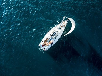 aerial photo of sailboat yacht top view, isolated on the sea texture. participant of sea regatta 