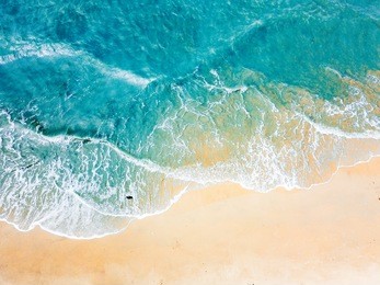 top view of blue aqua sea water. capture by drone. capture sea wave and beach in summer by drone.