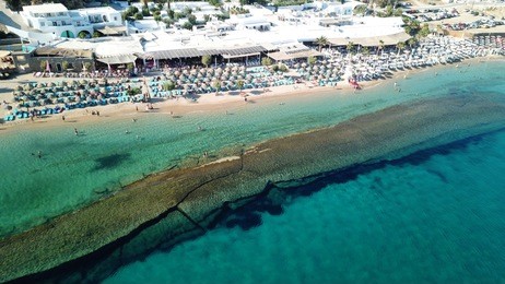 aerial drone photo of famous turquoise and sapphire clear water beach of paradise in popular island of mykonos, cyclades, greece