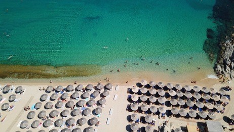 aerial drone, bird's eye view photo of iconic and famous beach of super paradise with sapphire and emerald clear water sea, mykonos island, cyclades, greece
