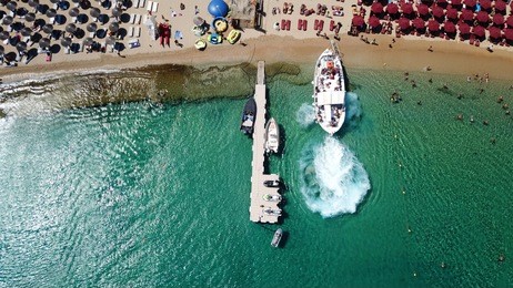 aerial drone, bird's eye view photo of iconic and famous beach of super paradise with sapphire and emerald clear water sea, mykonos island, cyclades, greece