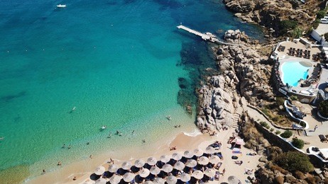 aerial drone, bird's eye view photo of iconic pool club in famous super paradise beach, mykonos island, cyclades, greece