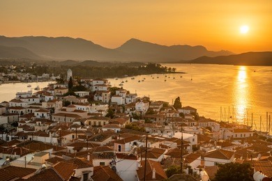 sunset on poros island in aegean sea, greece.