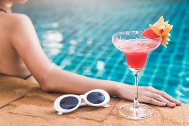 young back woman in bikini swimming pool drink cocktail, vacation summer holiday concept