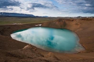 víti crater filled with a green lake at krafla calendra during a cloudy day in iceland
