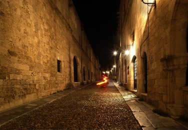 medieval avenue of the knights at night, a cobblestone street in rhodes citadel , greece