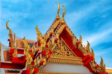 the orange roof of the marble temple, also known as wat benhamabofit in bangkok. thailand