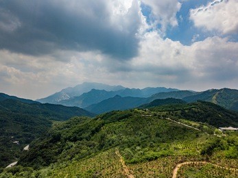 far view of mount tai in summer time, with its peak was surrounded by cloud, mount tai range is layered clearly. 