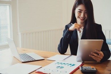 beautiful attractive young asian business woman working with tablet at the office.
