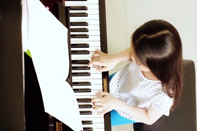 asian girl long hair practicing piano.