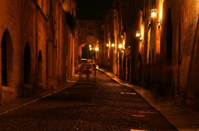 medieval avenue of the knights at night, a cobblestone street in rhodes citadel , greece