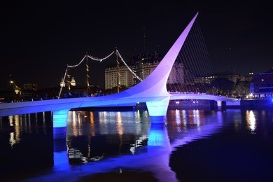 night photo of puerto madero with woman´s bridge, buenos aires, argentina. 