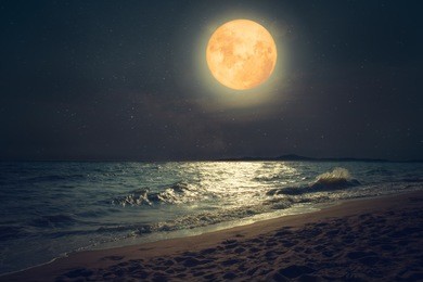 beautiful fantasy tropical sea beach. full moon (super moon) with star over seascape in night skies. serenity nature background at nighttime. vintage and retro color filter style.
