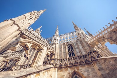 view of gothic architecture and art on the roof of milan cathedral (duomo di milano), italy.