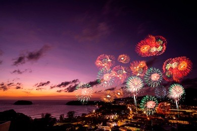 multicolor firework celebration over the sea in twilight sky kata beach, phuket, thailand at the night sky. blurred bokeh for background and texture. concept merry christmas and welcome new year.
