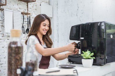 startup successful small business owner beauty girl using coffee machine in coffee shop restaurant. portrait of young asian tan woman barista cafe owner. sme entrepreneur business concept