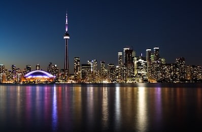 night view of a city with reflection of the lights in the water