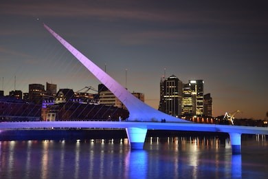 puerto madero with woman´s bridge after sunset, buenos aires, argentina