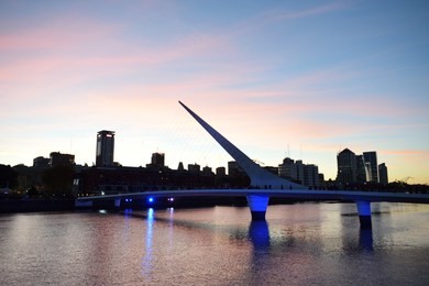 puerto madero with woman´s bridge after sunset, buenos aires, argentina