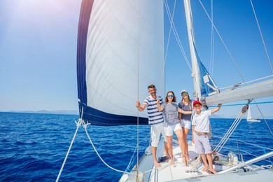 happy family with adorable daughter and son resting on a big yacht