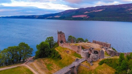 urquhart castle and loch ness in the evening - aerial drone view