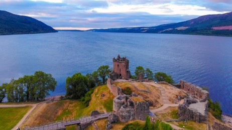 urquhart castle and loch ness in the evening - aerial drone view