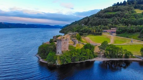 urquhart castle and loch ness in the evening - aerial drone view