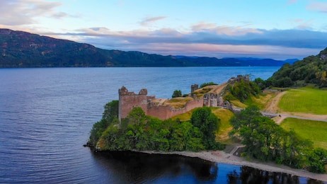urquhart castle at famous lake loch ness in the evening - aerial view
