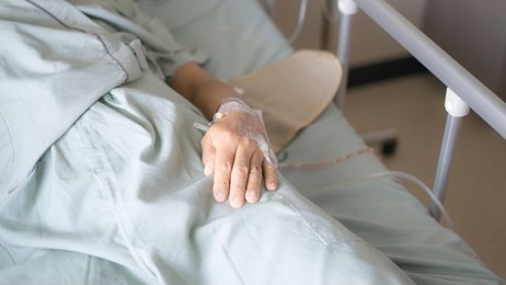 the patient is lying down in bed after surgery.