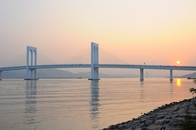 pte. de sai van bridge at sunset with reflections in macau