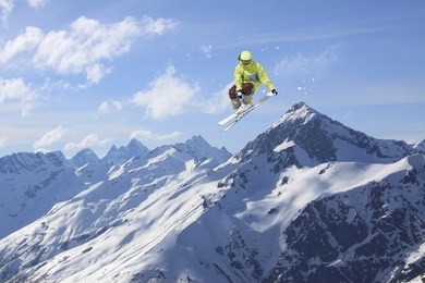 flying skier on mountains. extreme winter sport.
