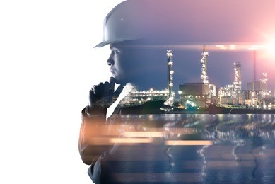 the double exposure image of the engineer thinking overlay with oil refinery image.the concept of energy, engineering, construction and industrial.