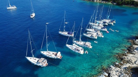 aerial photo of sail boats and yachts docked in traditional fishing village of fiskardo, cefalonia island, ionian, greece
