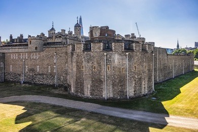 view of tower of london from outside walls at early morning. tower of london - historic castle on north bank of river thames in central london - a popular tourist attraction. london, great britain.
