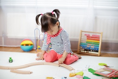 baby girl play toy blocks at home