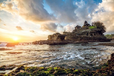 tanah lot water temple in bali during sunset. famous hindu temple main bali landmark. indonesia.