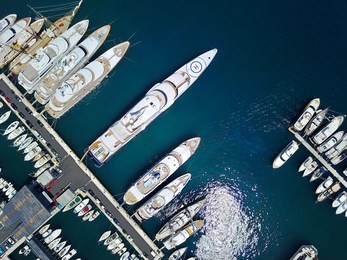 a stunning view of mega yachts in port hercules, monaco. 