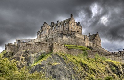edinburgh castle on castle rock in edinburgh, scotland, uk against dark rainclouds