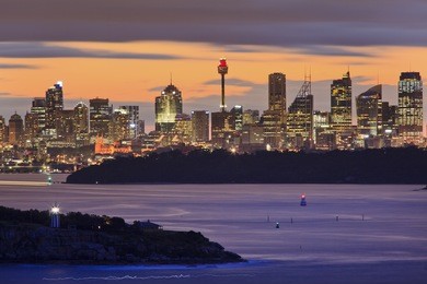 australia sydney city cbd view from north head entrance to sydney harbour at sunset with illuminated lights and blurred water