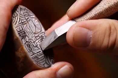 chinese craftsman carving a stone seal