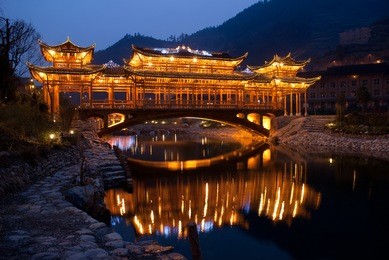 night scence of ancient wind-rain bridge in xijiang hmong village