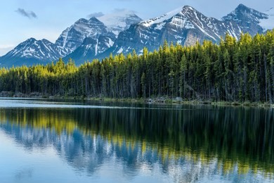 herbert lake - a spring sunset view of herbert lake and its surrounding high mountain peaks, banff national park, ab, canada.