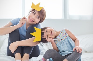 portrait of mother and child daughter playing having fun together. beautiful funny girl and mommy have crowns on sticks. fun love family lifestyle single mom love mother’s day holiday concept