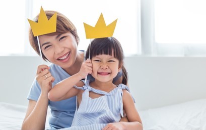 portrait of mother and child daughter playing having fun together. beautiful funny girl and mommy have crowns on sticks. fun love family lifestyle single mom love mother’s day holiday concept