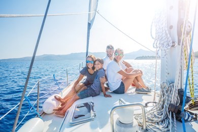 happy family with adorable daughter and son resting on a big yacht